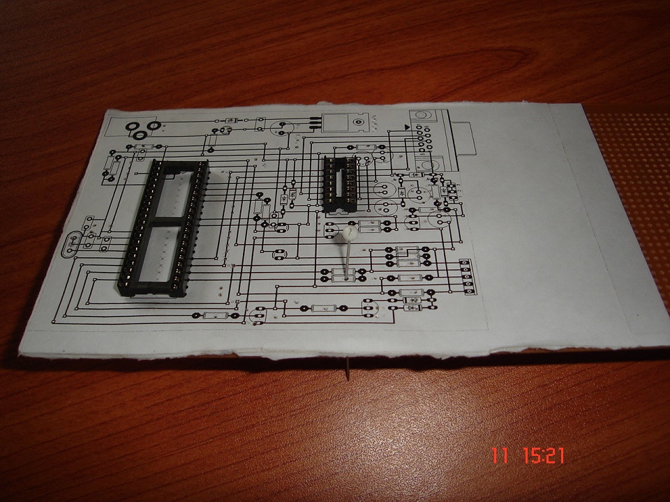 2 PCB is printed on paper and placed on components side   a pin is used to find strip cut places